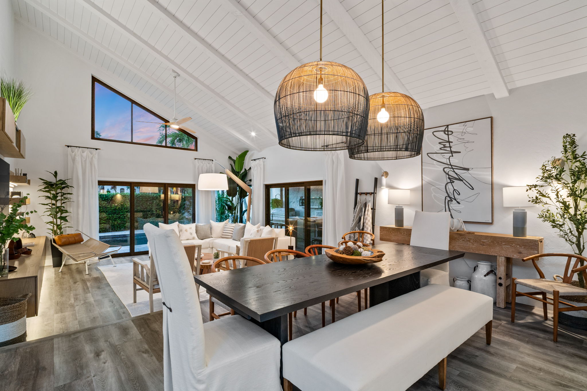 Elegant dining and living space with vaulted ceilings